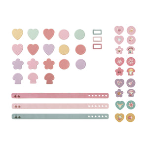 A set of pastel-colored planner stickers and decorative elements, including hearts, circles, flowers, mushrooms, and horizontal bars in soft pink, lavender, mint green, and pale yellow, arranged on a plain white background.