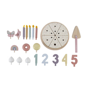 A flat lay displaying all the individual pieces of the pink wooden birthday cake set, including numbers, candles, toppings, and serving tools.