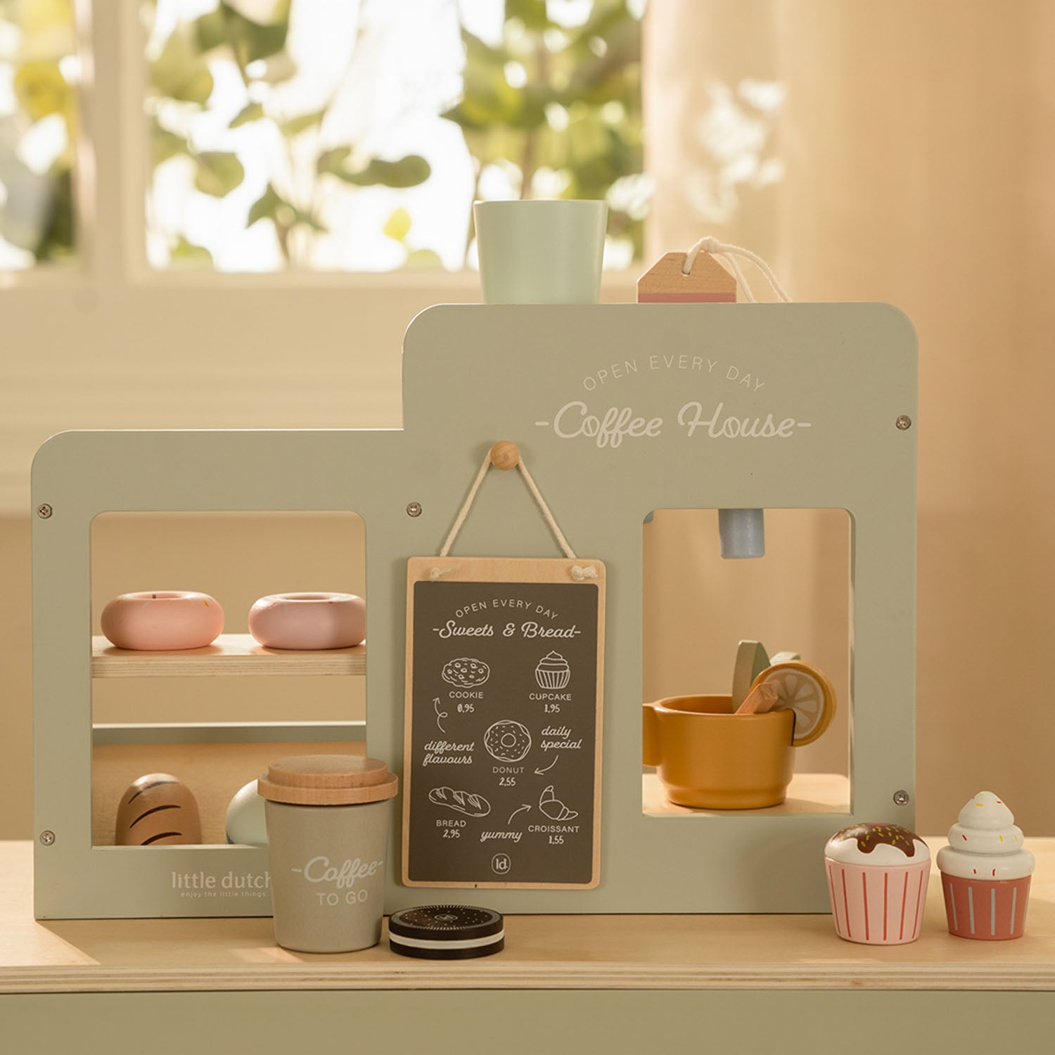A lifestyle shot showing the reverse, customer-facing side of the coffee corner set, featuring a small serving counter and menu board.