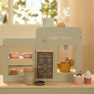 A lifestyle shot showing the reverse, customer-facing side of the coffee corner set, featuring a small serving counter and menu board.