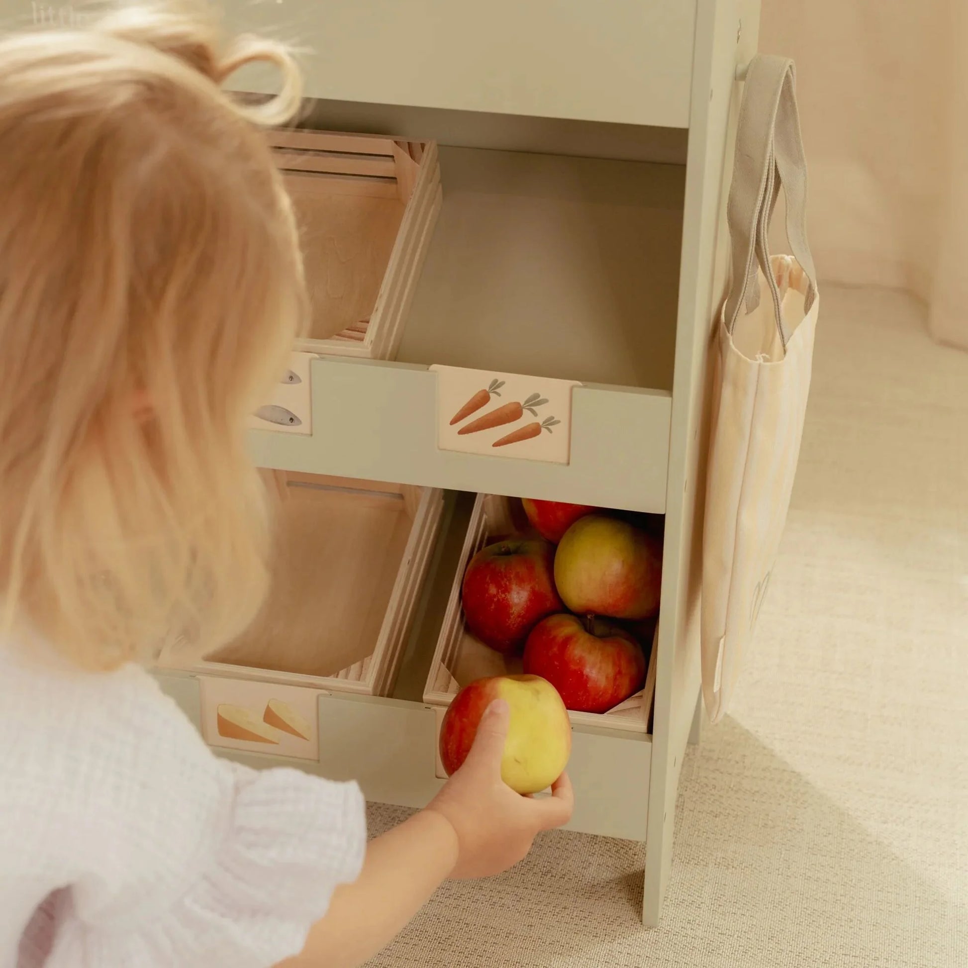 Child enjoying café role play with Little Dutch market stall.