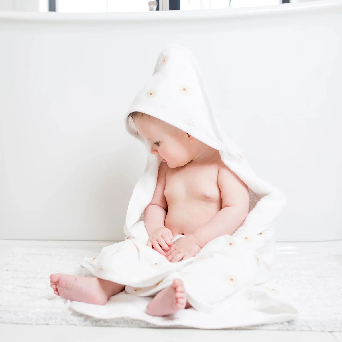 A soft cotton baby towel with a hood is comfortable and safe.