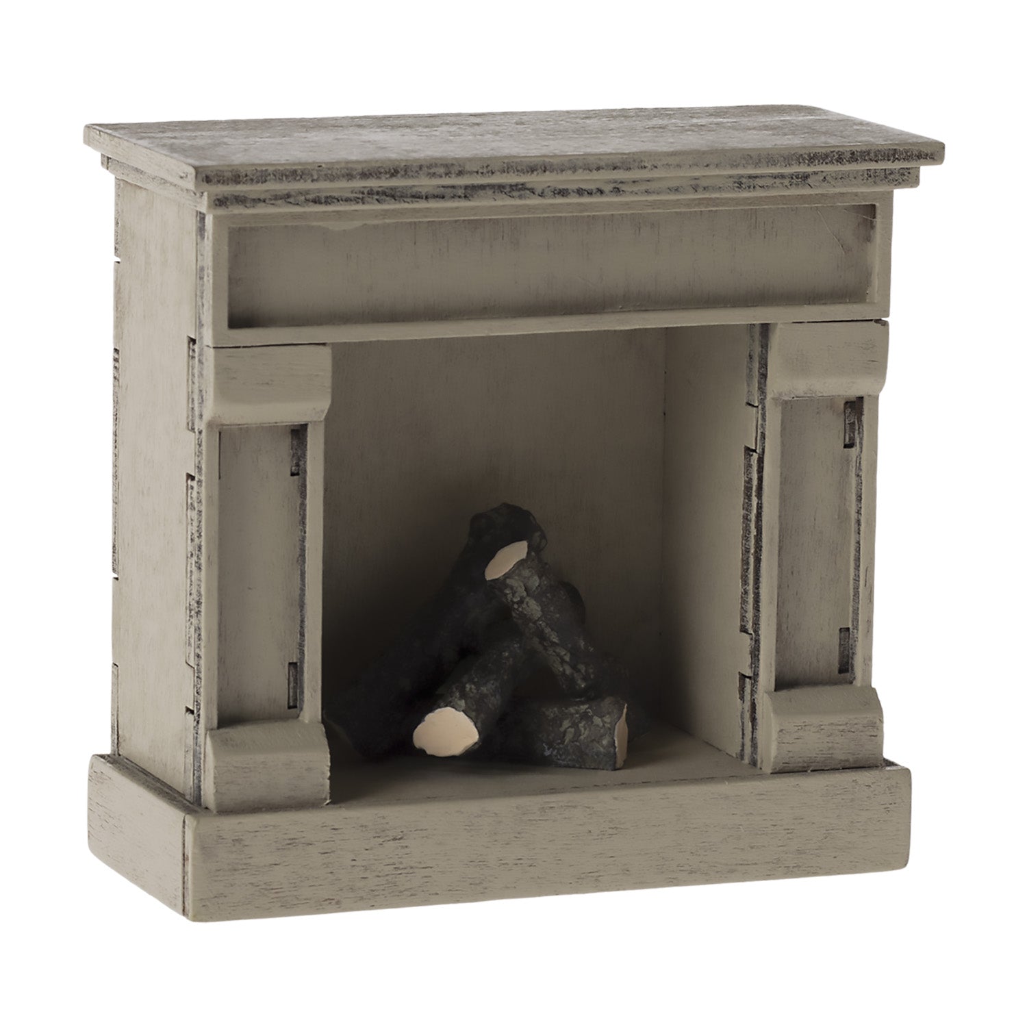 The Maileg fireplace can be used in a dollhouse.