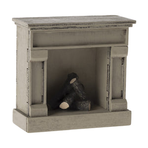 The Maileg fireplace can be used in a dollhouse.