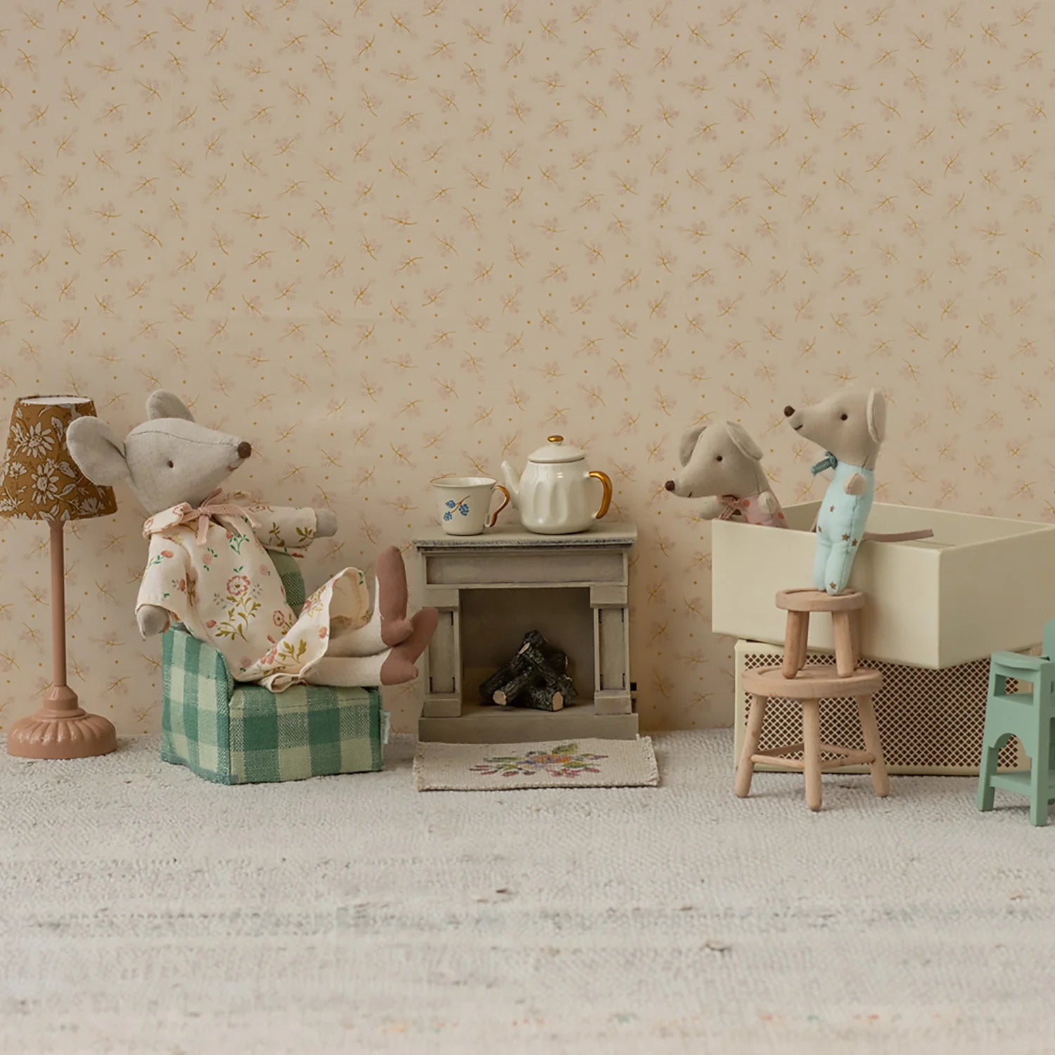 Maileg mouse with miniature fireplace.