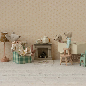 Maileg mouse with miniature fireplace.