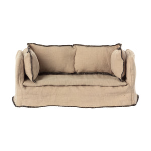 A beige miniature couch with a wooden frame and linen upholstery, designed for dollhouses.