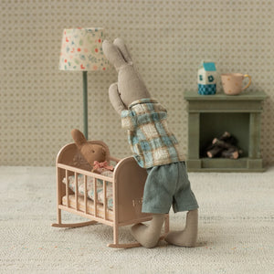 Miniature metal cradle with gently curved rocking legs.