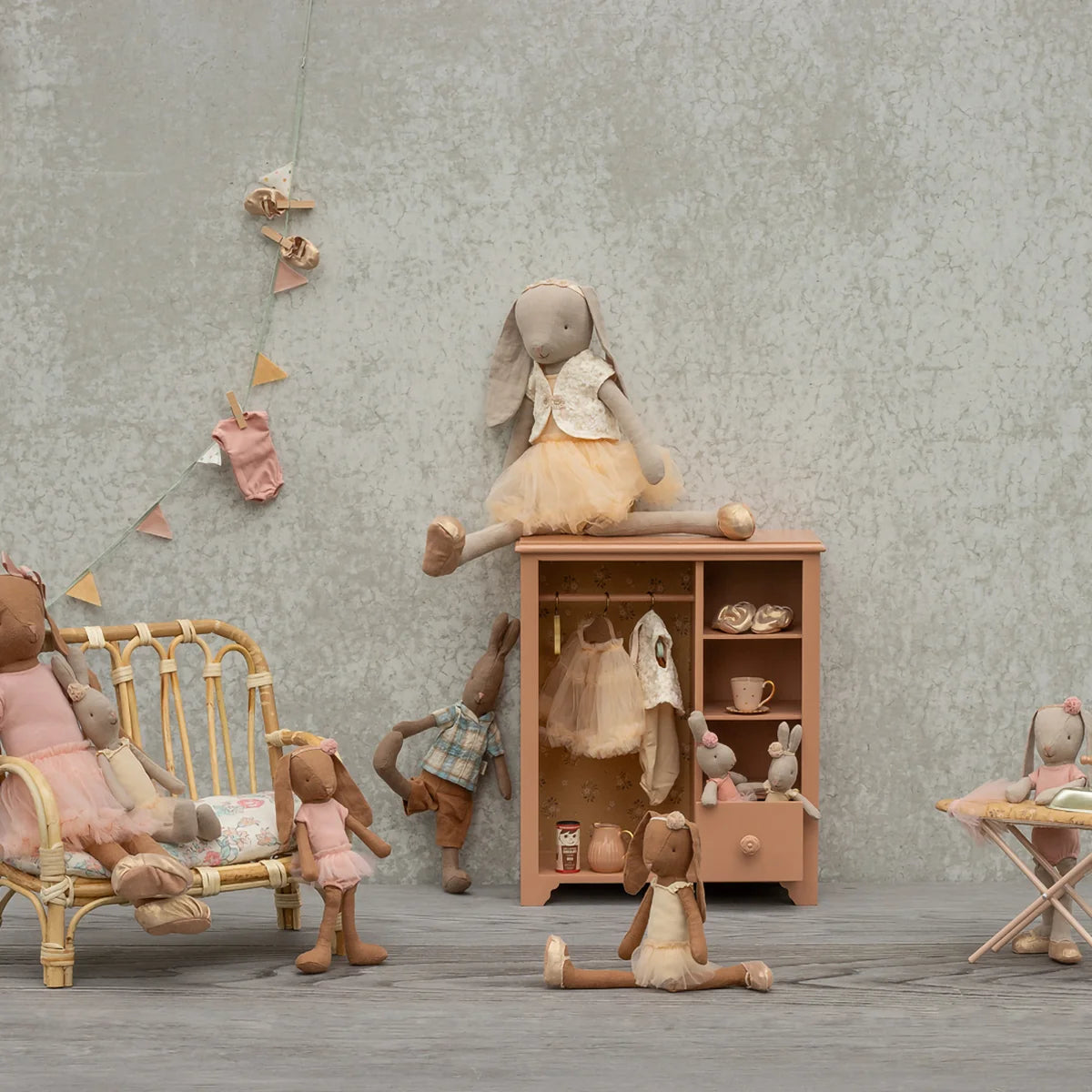 Maileg dark-powder closet styled with miniature clothes.