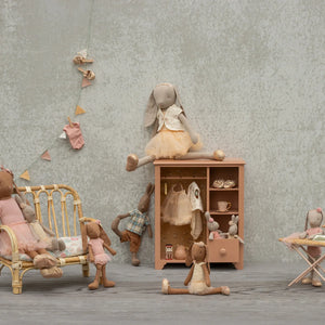 Maileg dark-powder closet styled with miniature clothes.