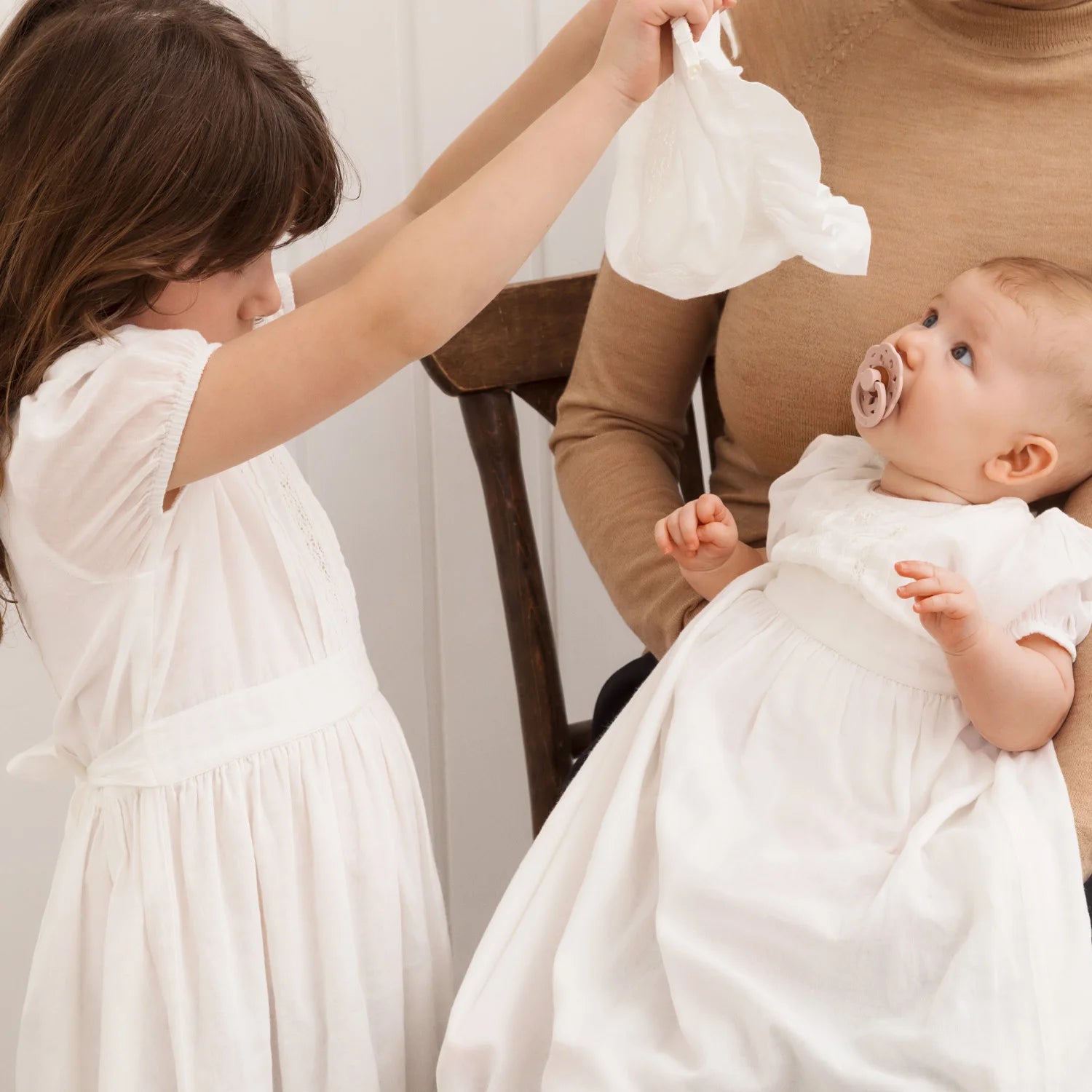 Baby wearing MarMar Copenhagen Daisa Long Christening Dress for special occasion.