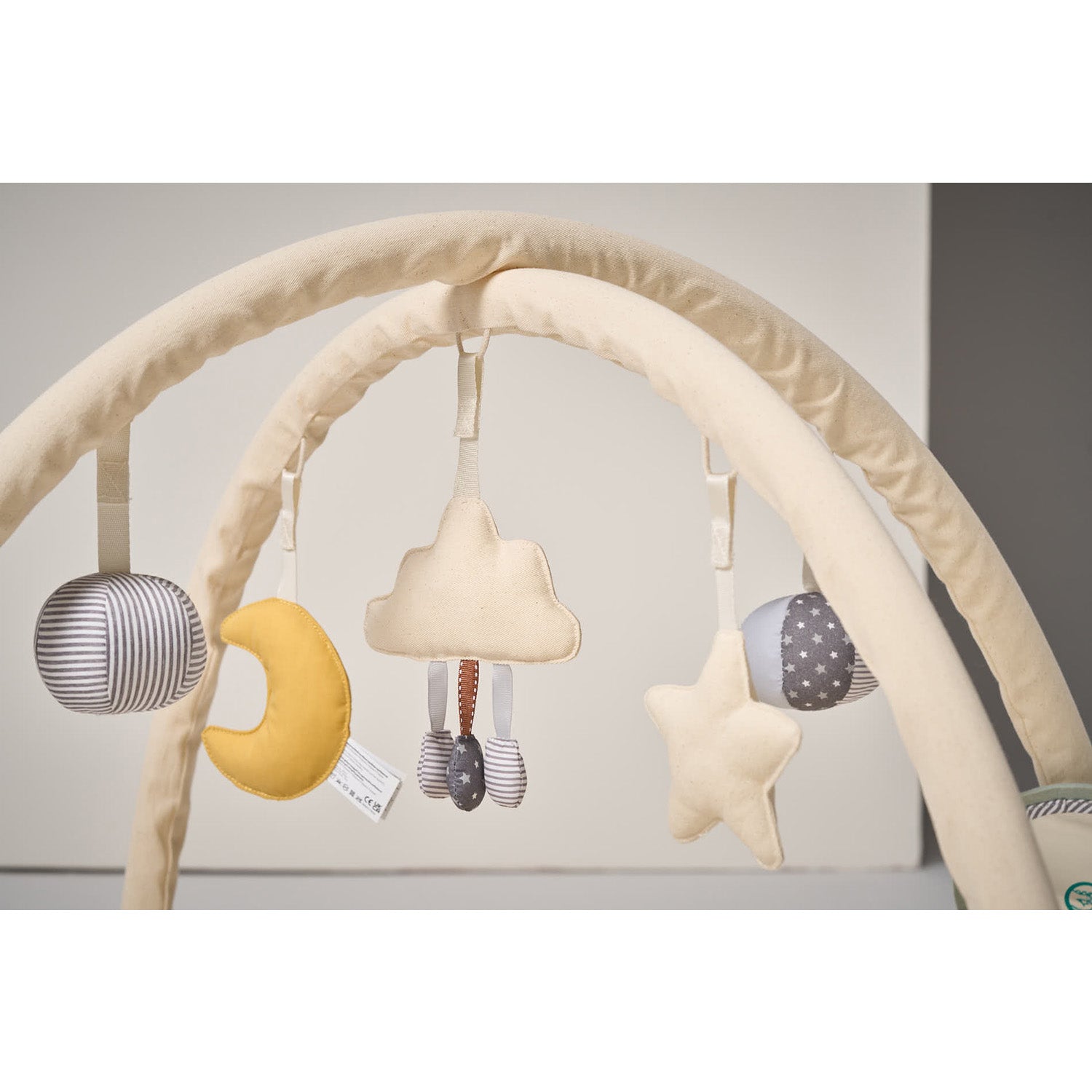 Baby crib mobile with various hanging toys on a plain background