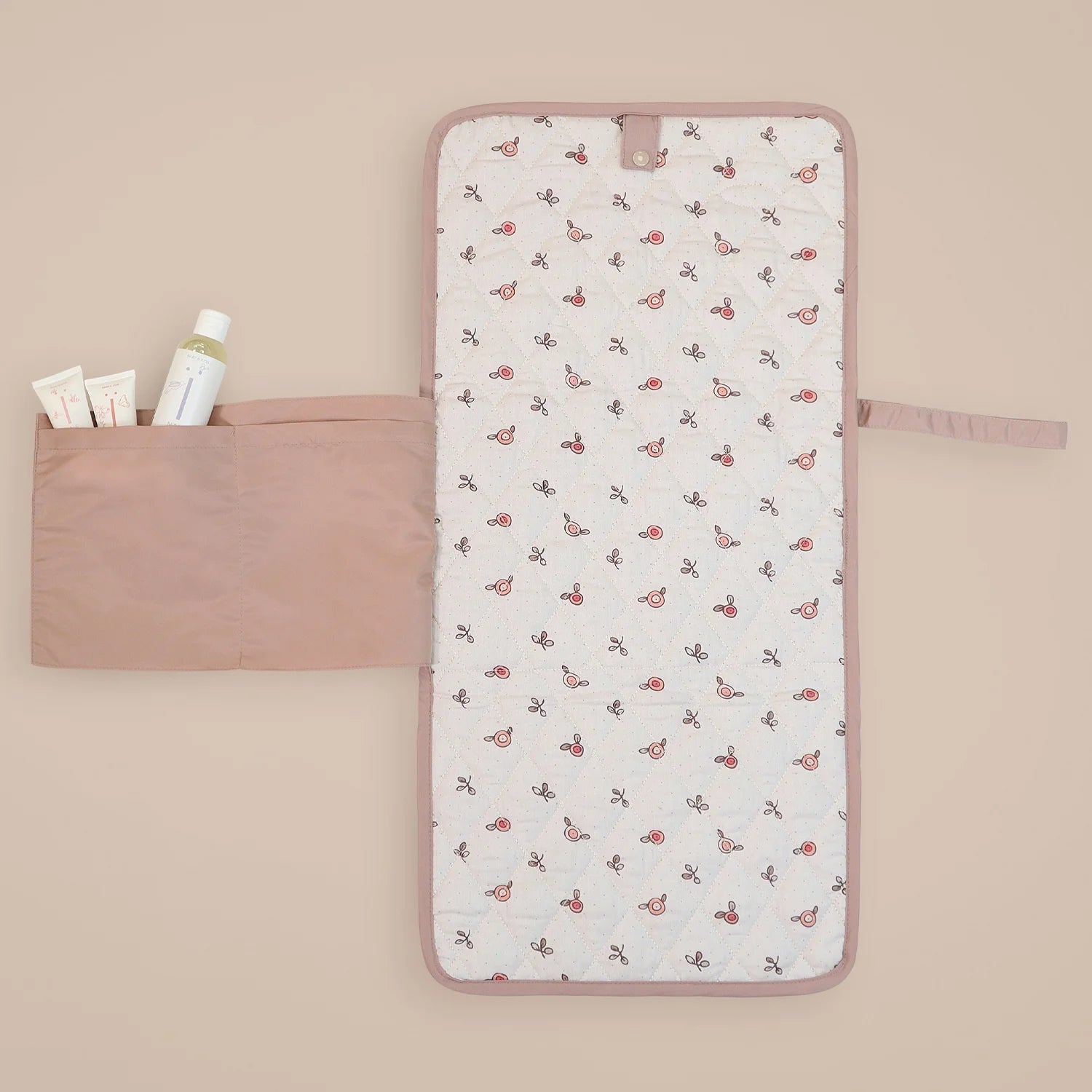 The MiniDream infant changing mat, available in a baby pink colour, features an inside design with a pocket.