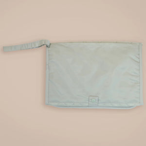 Portable baby mat with pockets in sage green colour.