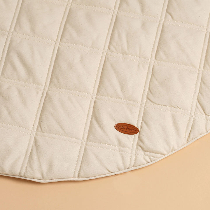 Close-up of the MiniDream Organic Play Mat's soft fabric and subtle design