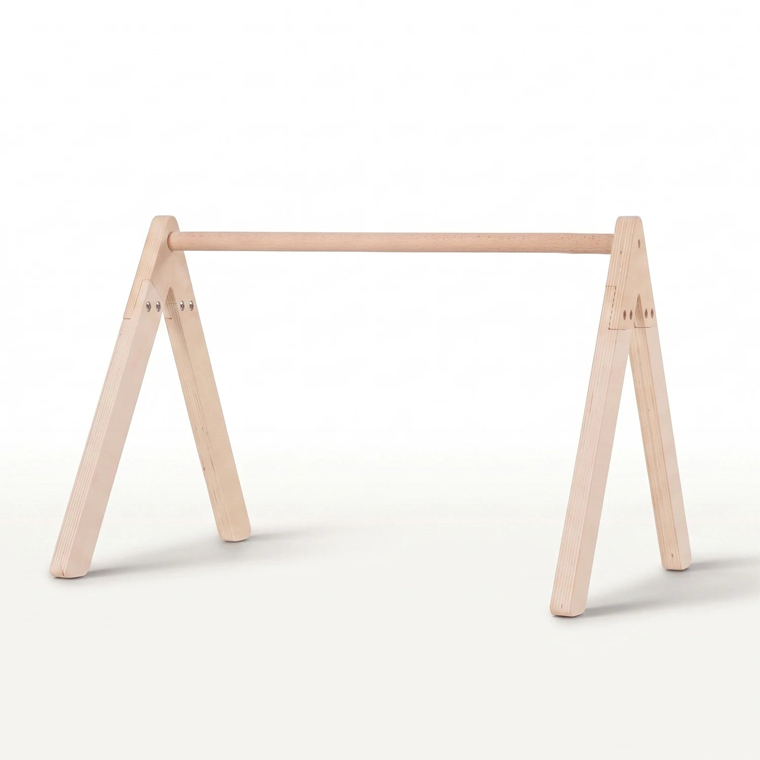 A minimalist light natural wood baby gym frame stand with a horizontal top rail.