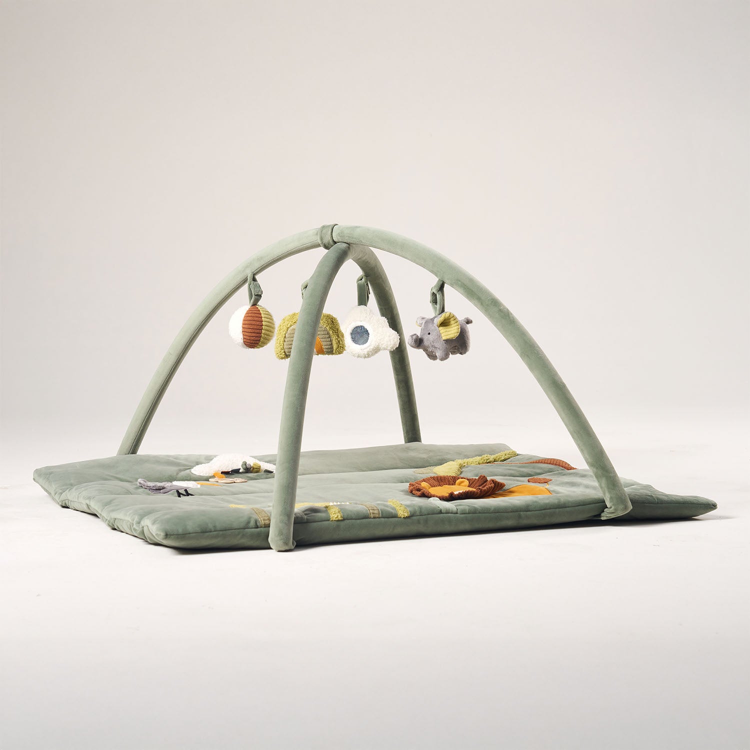 Baby play mat with toys on a light gray background