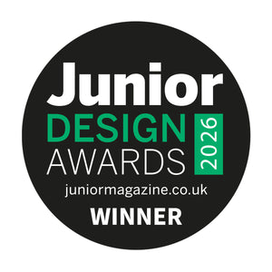 A circular black badge with white and green text reading 'Junior Design Awards 2026', 'juniormagazine.co.uk', and 'WINNER'.