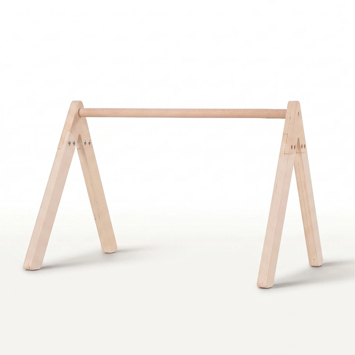 A minimalist light natural wood baby gym frame stand with a horizontal top rail.