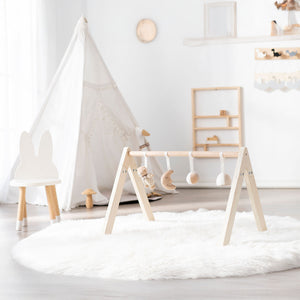 Newborn play gym with safe non-toxic materials and sturdy wooden frame