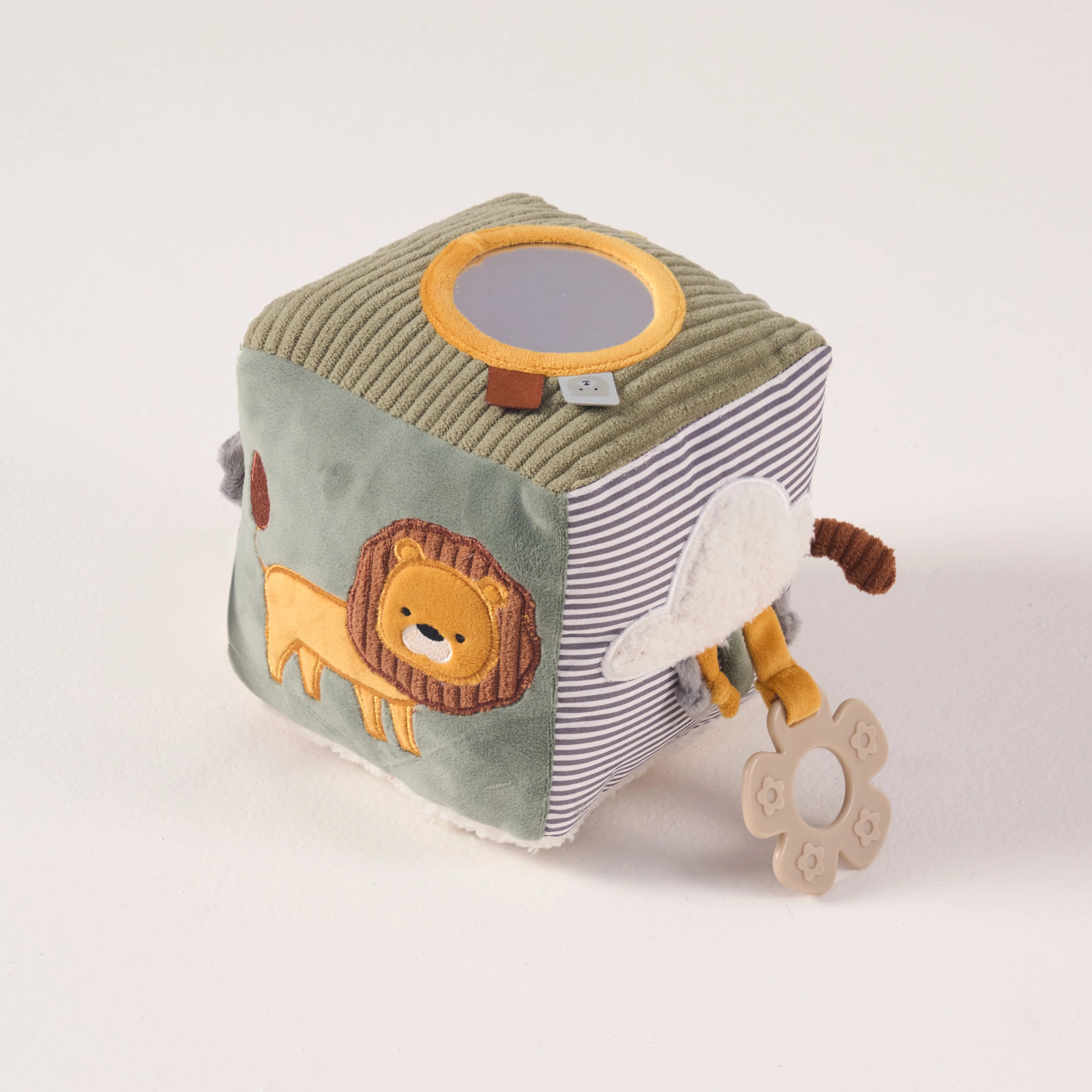 Angled view of the lightweight MiniDream baby sensory cube showing a soft lion face, top mirror, and flower-shaped teether.