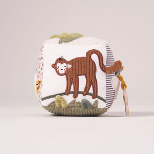Soft textured side of the MiniDream baby activity toy showing a playful monkey swinging from a jungle branch.