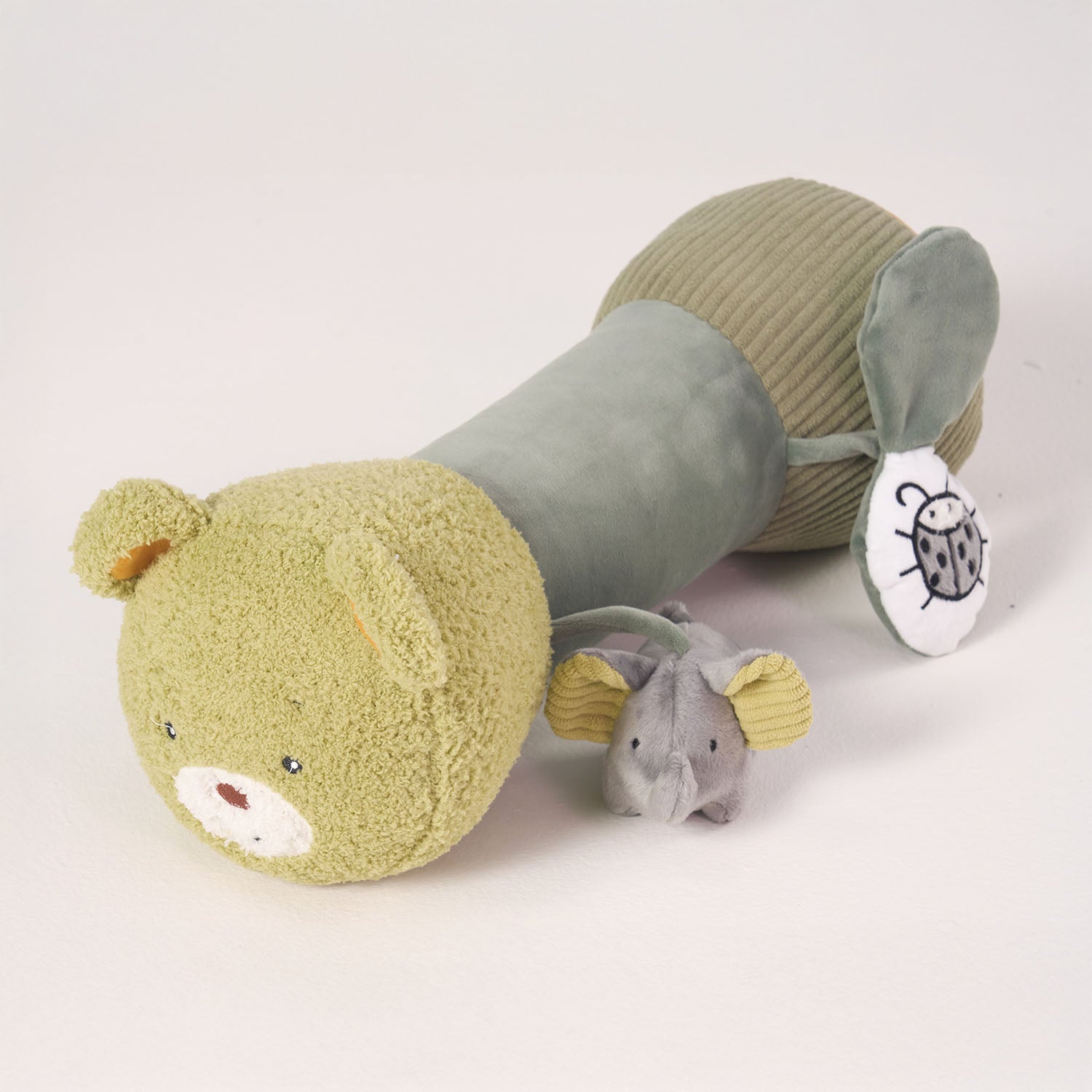 Tummy time roller with elephant plush toy and rattle leaf.