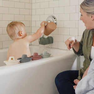 Toddlers playing with Bath Toy Boat Set in bathtub