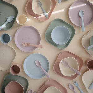 Mix match of fork and spoon with dinnerware plates.