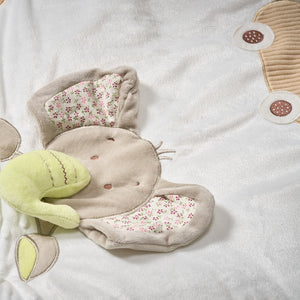 Plush toy crab with floral details on a soft surface