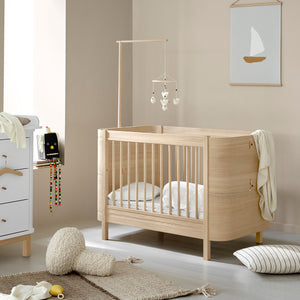 Durable oak wooden cot bed for small nursery spaces