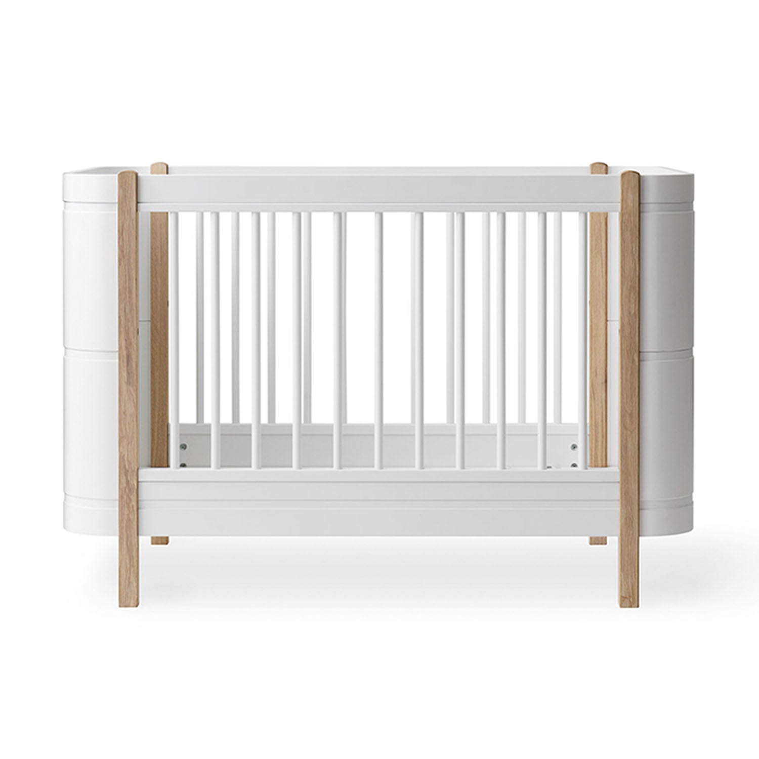 Wood Mini+ cot bed in white and oak with a clean Scandinavian design