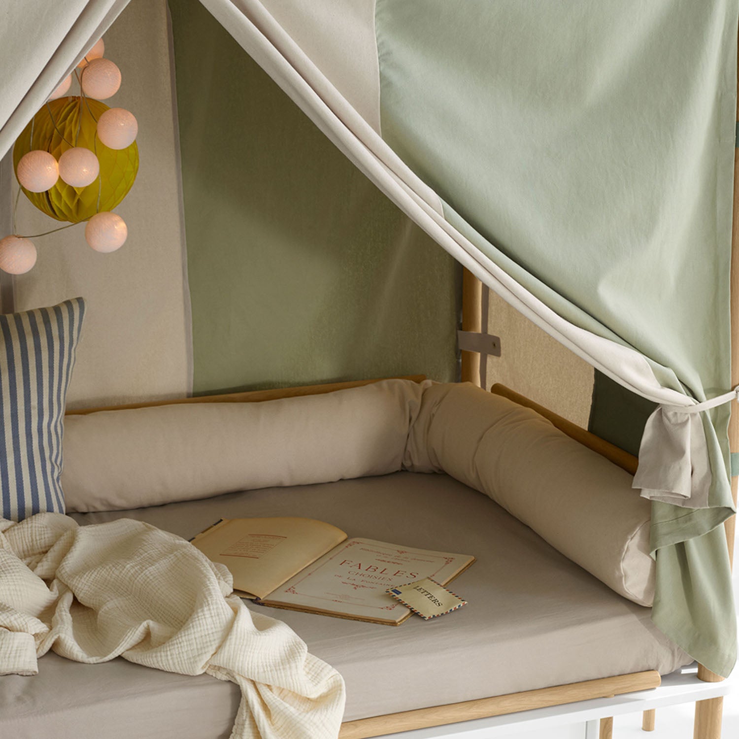 Oliver Furniture Camp Bed Snake in undyed canvas arranged along the edge of a Camp bed