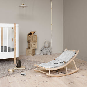 Baby rocker placed in calm Scandinavian nursery interior