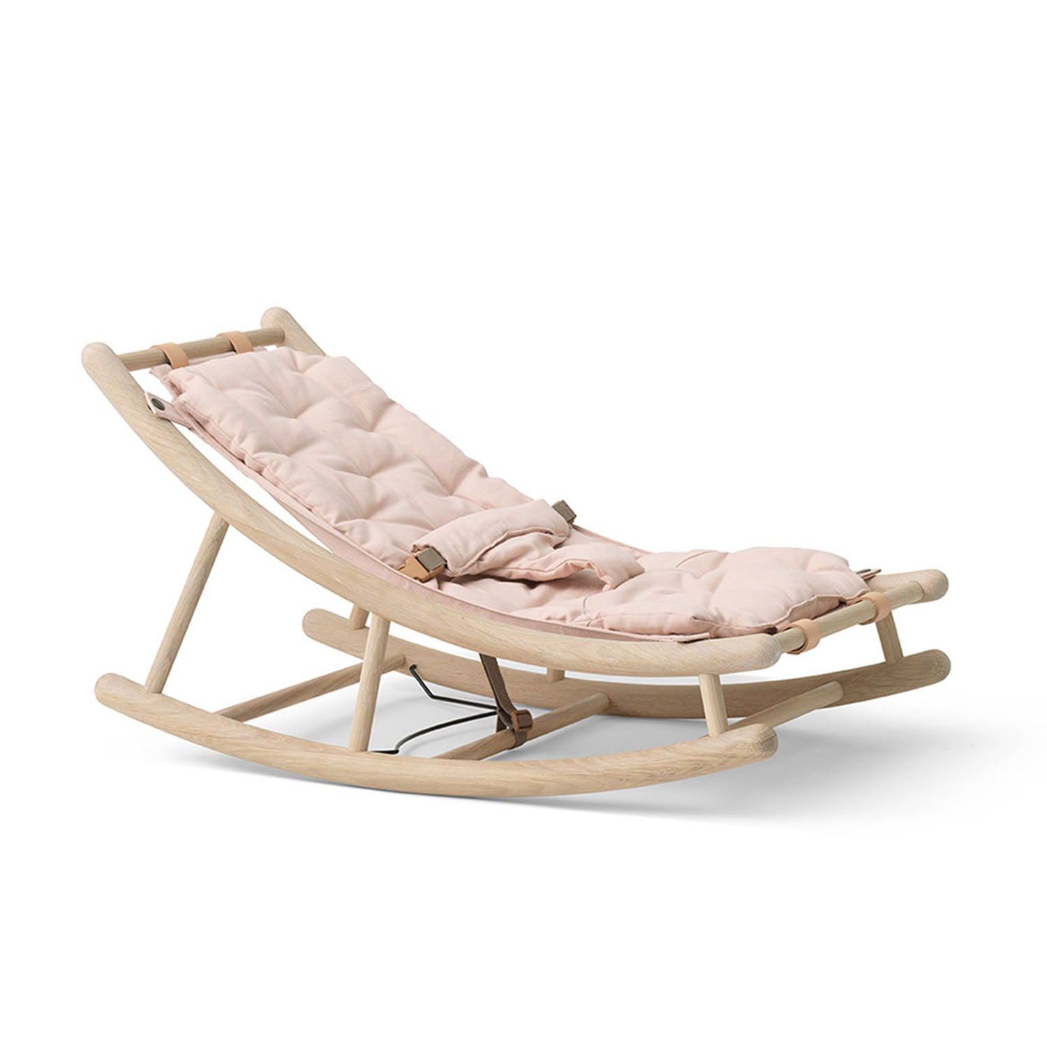 Side view of wooden rocker with white-oiled oak frame with oak rose cushion on white background