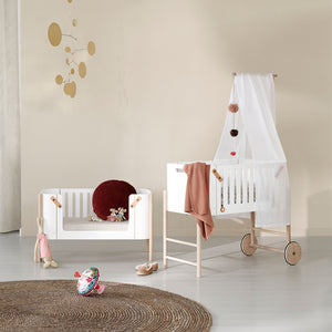 Daytime nursery setup showing co-sleeper in bright natural light