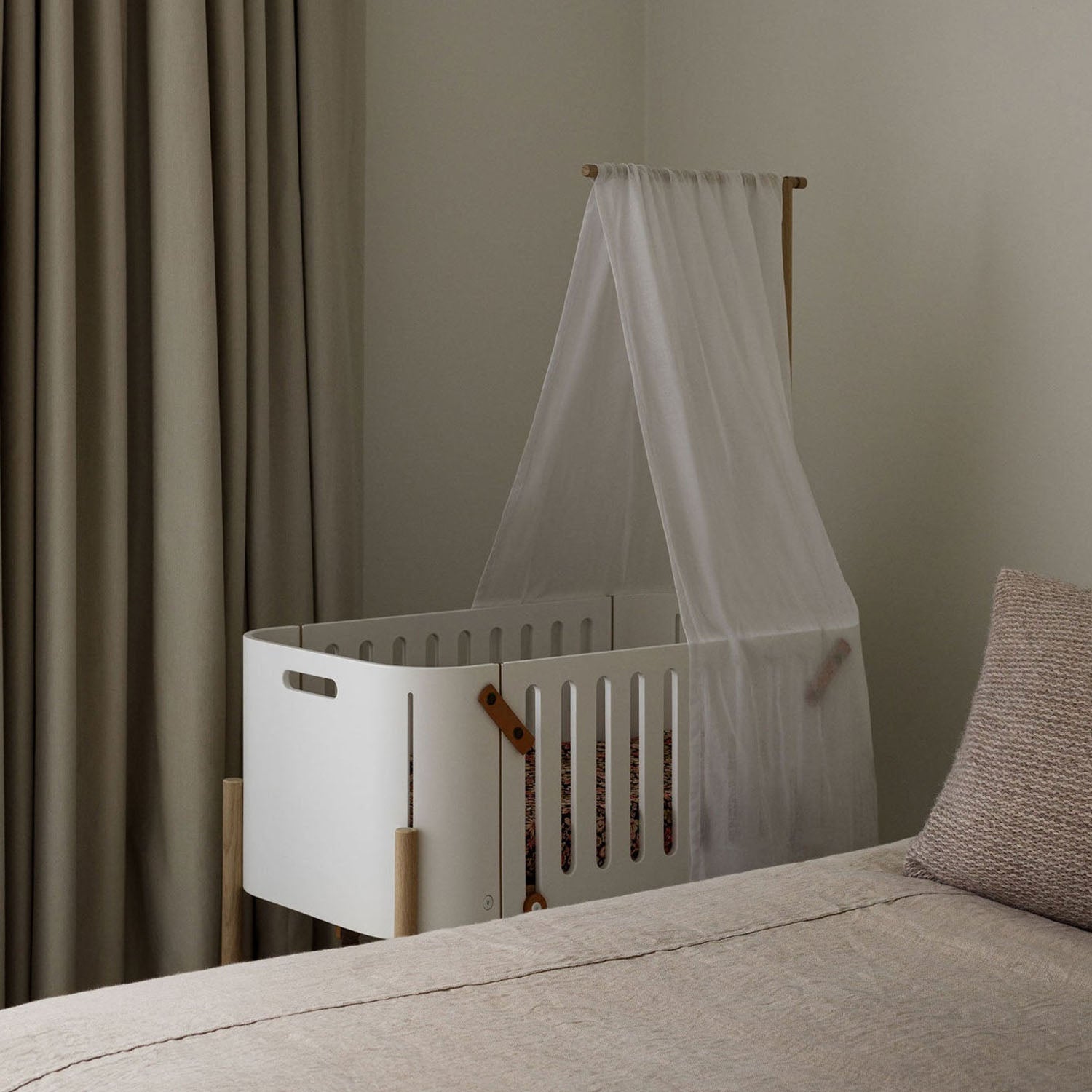 Canopy attached creating a soft, cosy sleep space in the wooden co-sleeper.