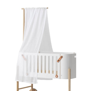 Co-sleeper bed transformed with a gentle canopy for light and draft protection
