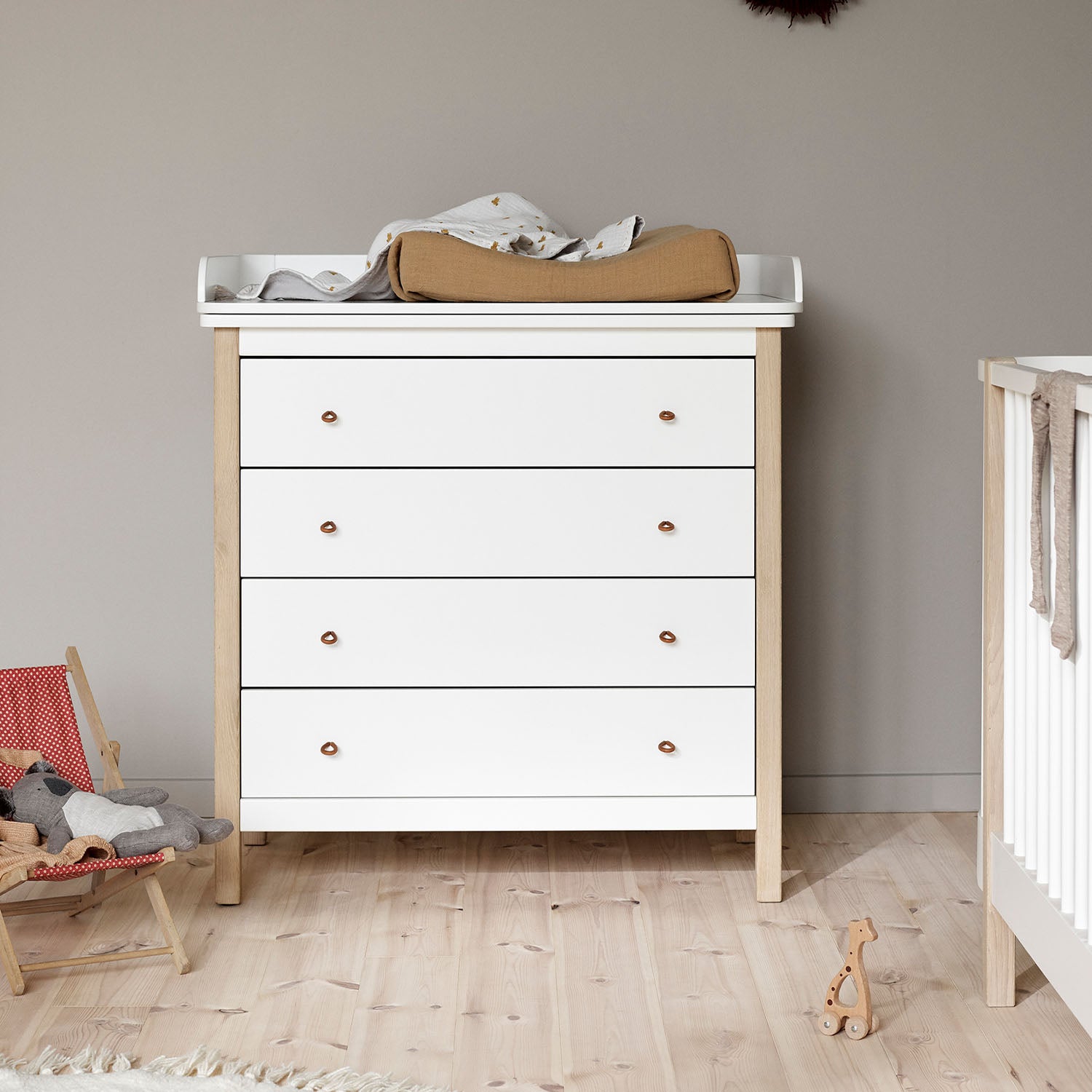 Nursery changing top fitted on top of the dresser