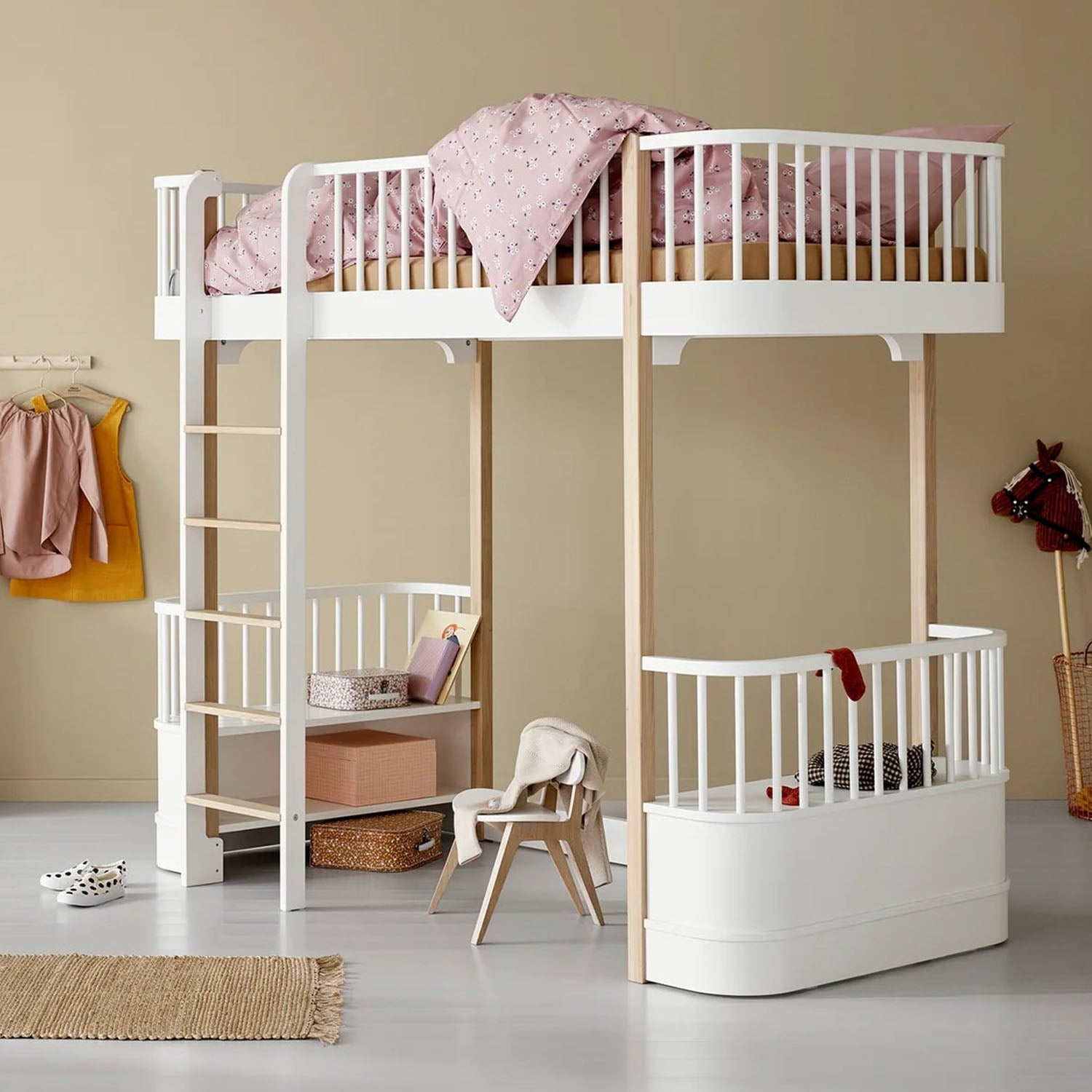 Cozy play area under white and oak loft bed with cushion and table