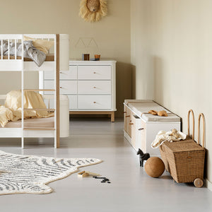 Low storage shelf used as a bench with cushion on top