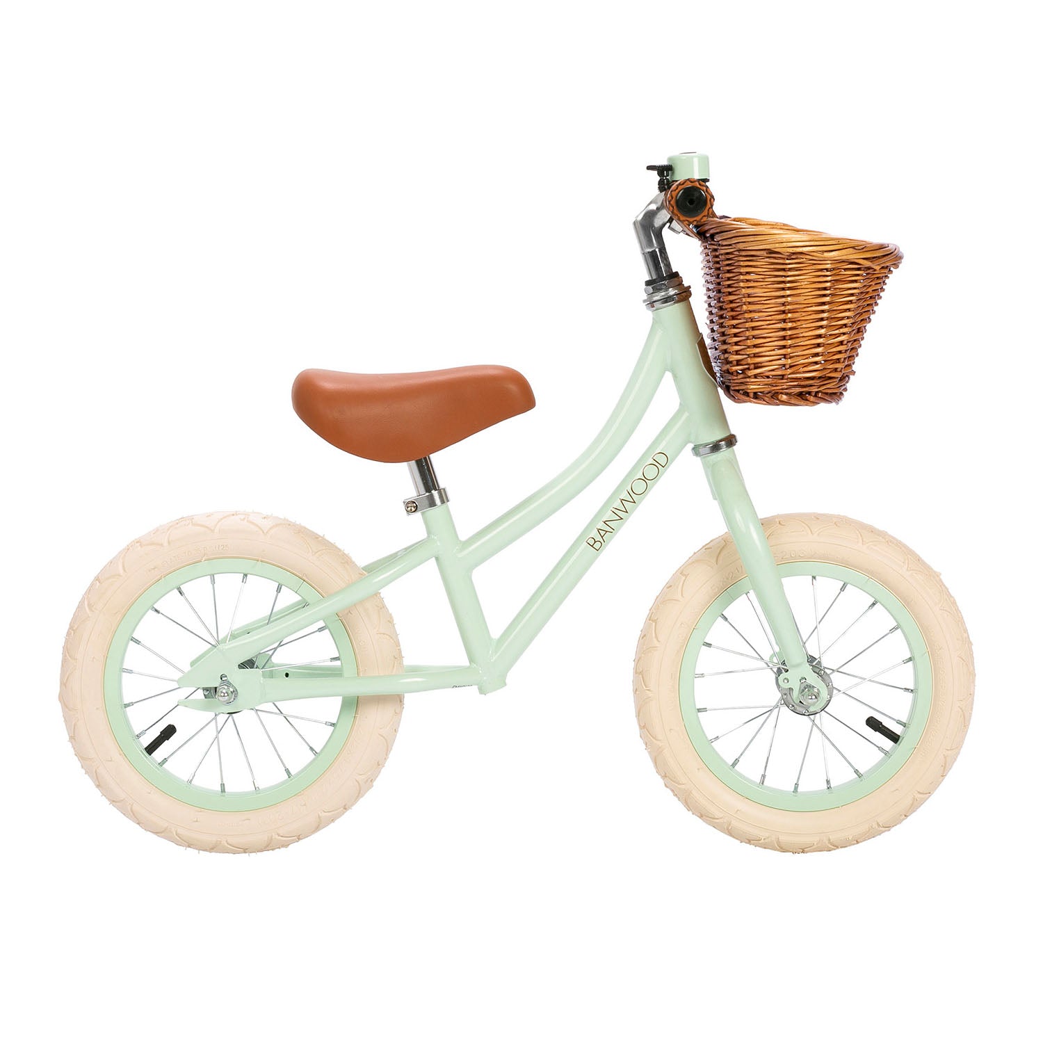 Children's balance bike with a wicker basket on a white background