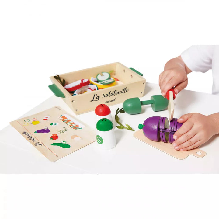 A child is using wooden kitchen accessories set