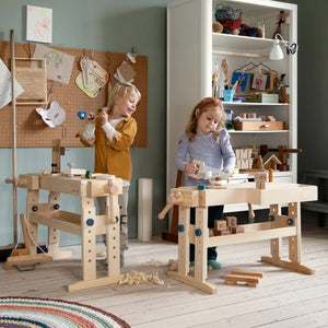 Child playing with wooden woodworking bench