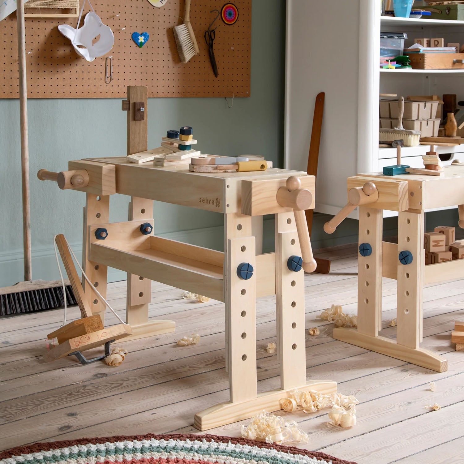 Wooden children’s workbench with adjustable height legs.