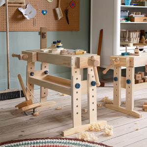 Wooden children’s workbench with adjustable height legs.