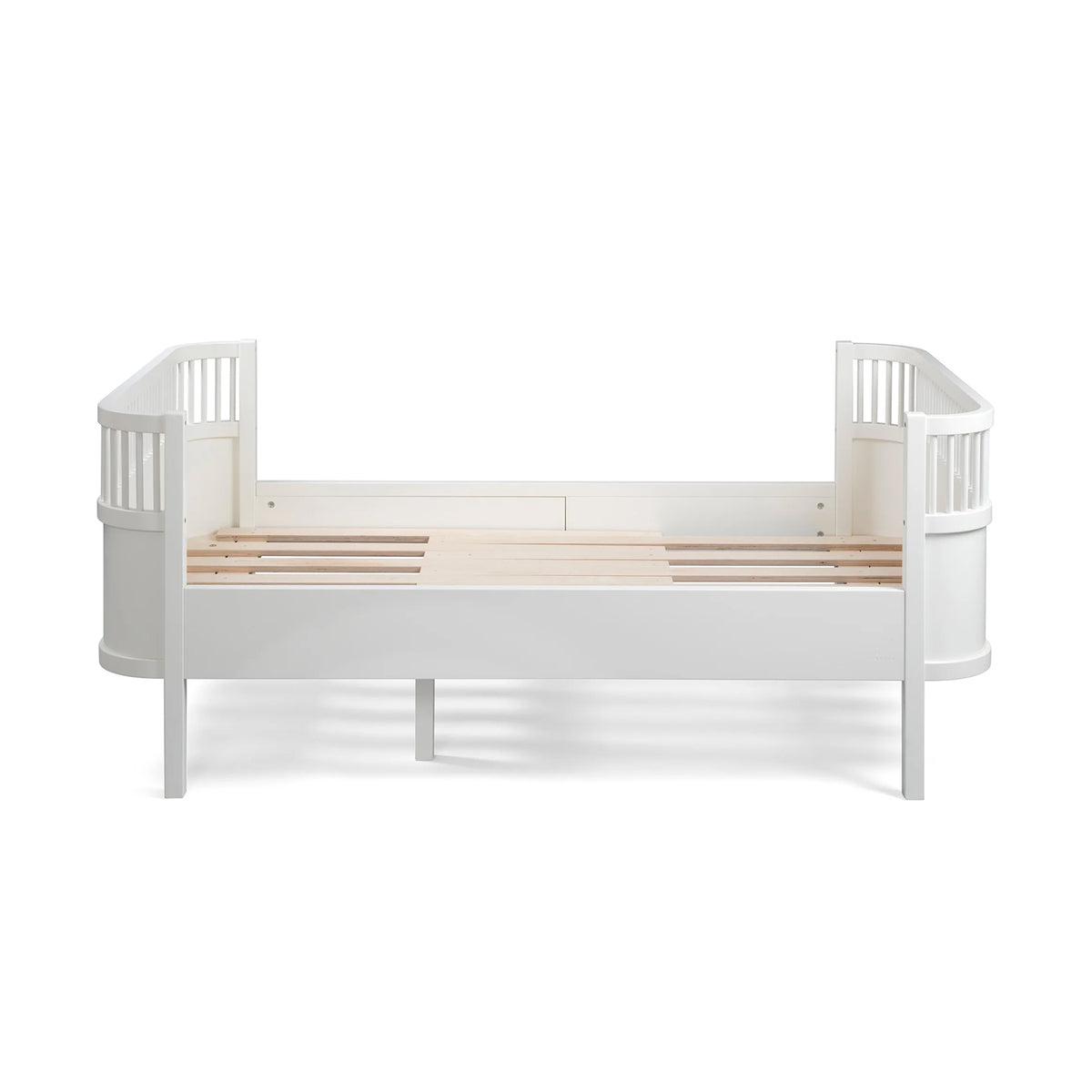 Classic white Sebra Junior & Grow cot bed, empty, showing slatted base and curved end panels, clean white finish