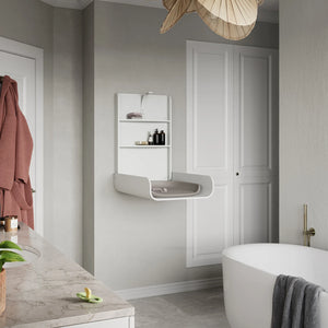 Close-up of Sebra wall changing table white finish folded down
