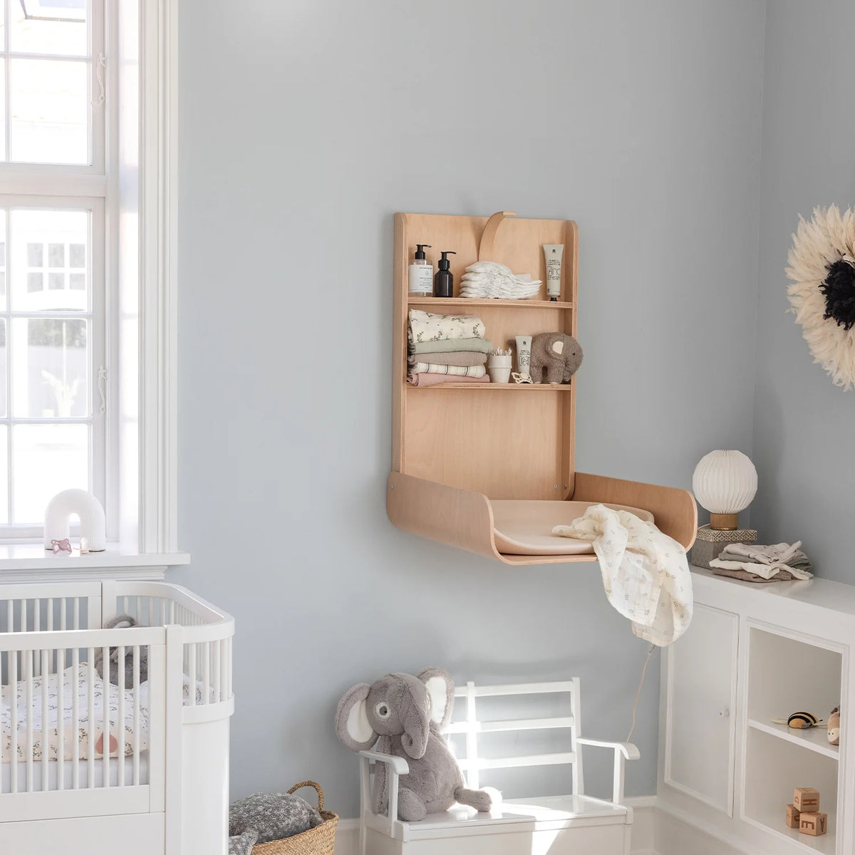 Sebra wall mounted changing table folded down in small bathroom