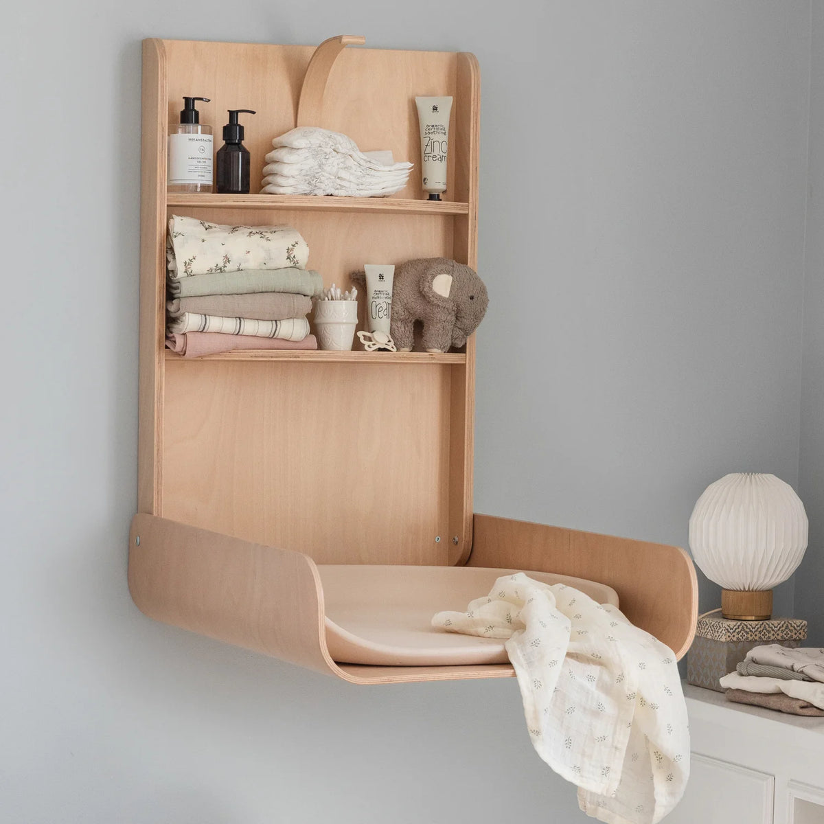 Sebra wall mounted changing table open with shelves in modern nursery